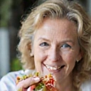 A happy senior woman enjoying a healthy salad.